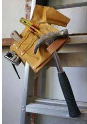 Tools of the Trade toolbelt on ladder
