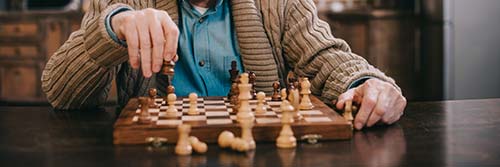 elderly person playing chess