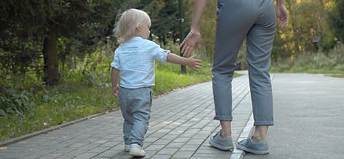 toddler reaching out to mom