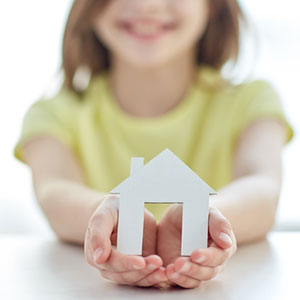 girl holding house