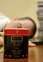 worker sleeping with coffee mug