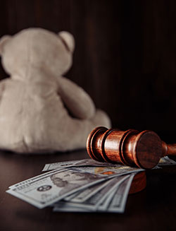teddy bear, money and gavel