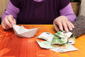paper boat and money in sock