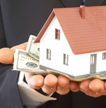 hand with house and money