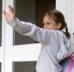 young girl waiving goodbye